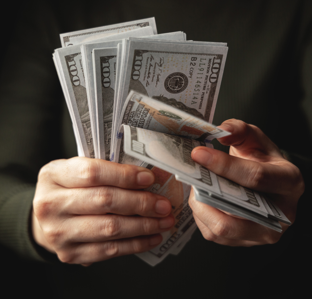 Hands counting cash for efficient payroll solutions