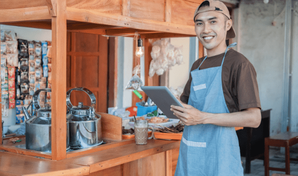 Store owner using tablet for online and offline selling